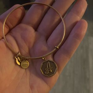 Alex and Ani “A” charm bracelet. “Like new condition,” very slight wear.